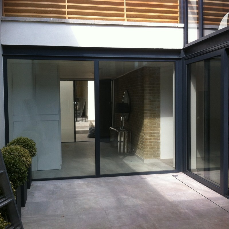 Floor-to-ceiling sliding doors opening to courtyard in Thamesmead