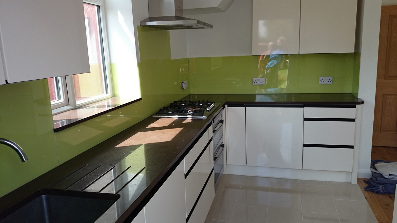 Lime green glass kitchen splashback installed by Thamesmead glaziers